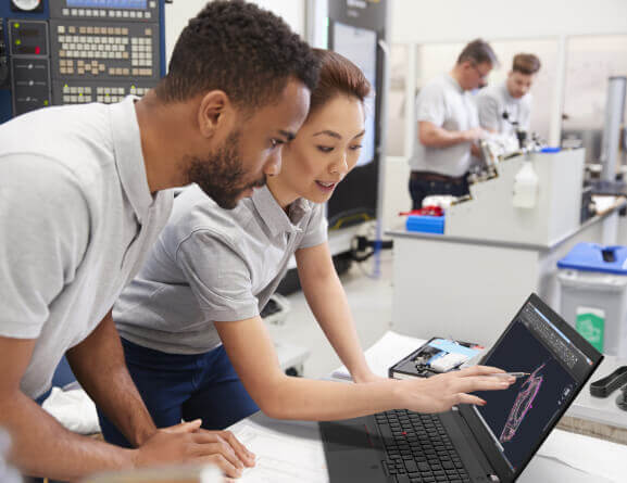 Lenovo ThinkPad P15v laptop: man and woman reviewing computer rendering on laptop screen in science lab.
