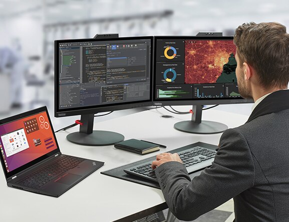 A man sits at a desk with the Lenovo ThinkPad P15 Gen 2 mobile workstation along with two large monitors displaying media and entertainment industry.