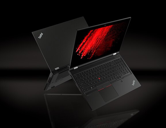 Two back-to-back Black Lenovo ThinkPad P15 Gen 2 laptops floating midair, open 90 degrees, showing keyboard, display, and partial back-side with burst of red color on screen.